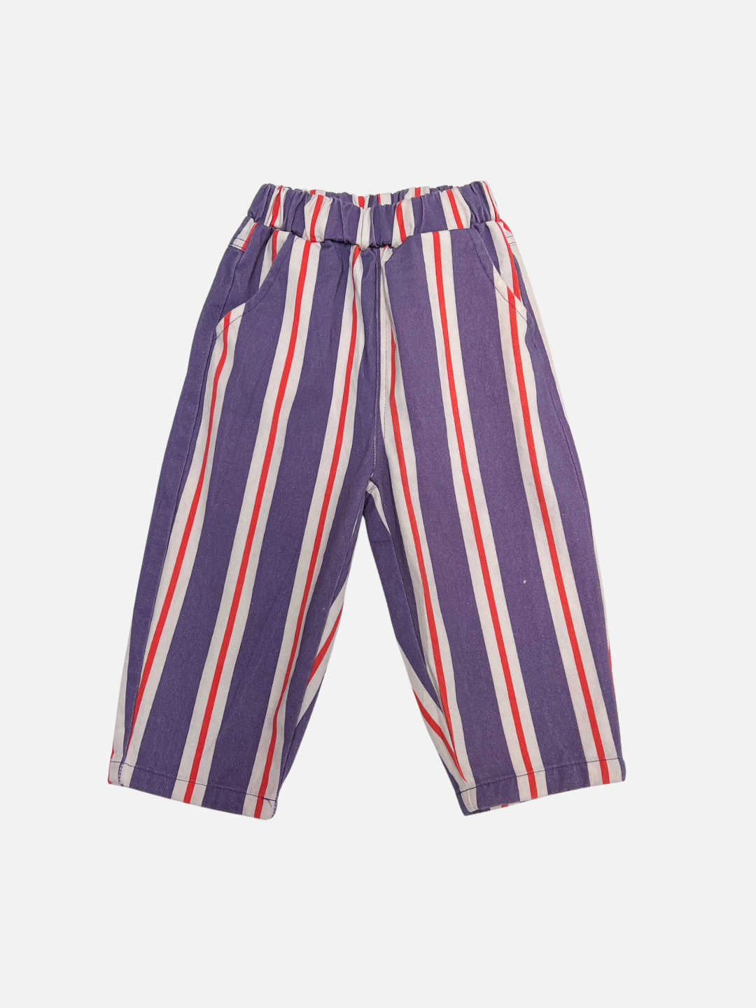 The STRIPE TWILL PANT is a pair of children's cotton twill pull-on pants with vertical purple, white, and red stripes, an elastic waistband, baggy fit, and side pockets, shown on a plain white background.
