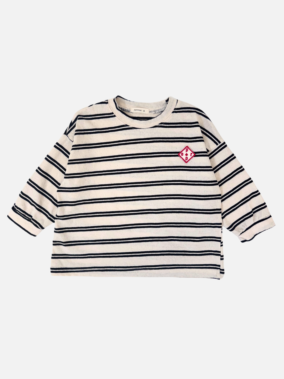 Black & White | The PEPPER LONGSLEEVE TEE features black and white stripes with a red embroidered chest design, embodying the playful style of a Korean kids brand. Its boxy fit offers comfort and style for young trendsetters.