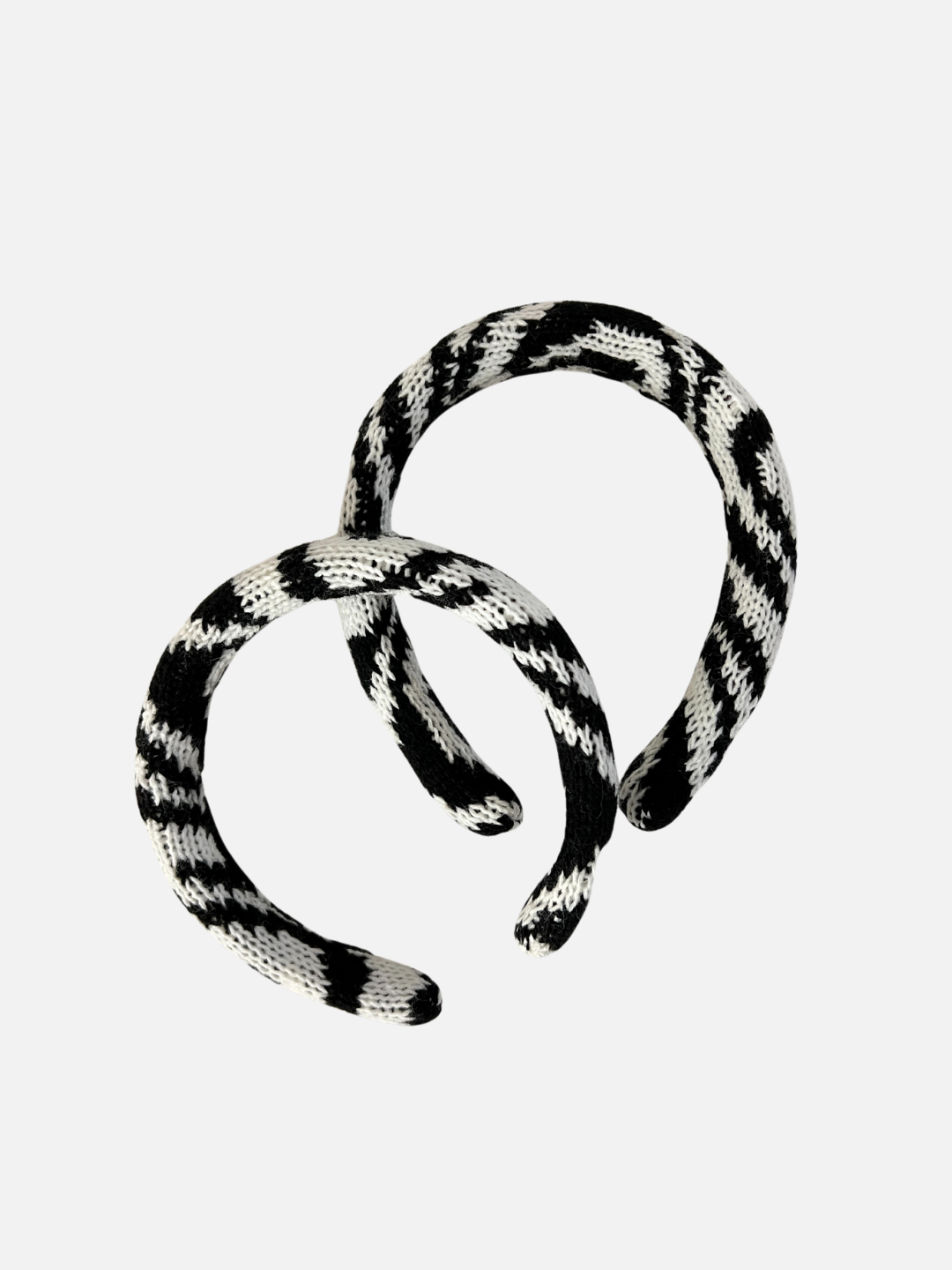 Two sizes of kids' knitted headband in swirls of black and white