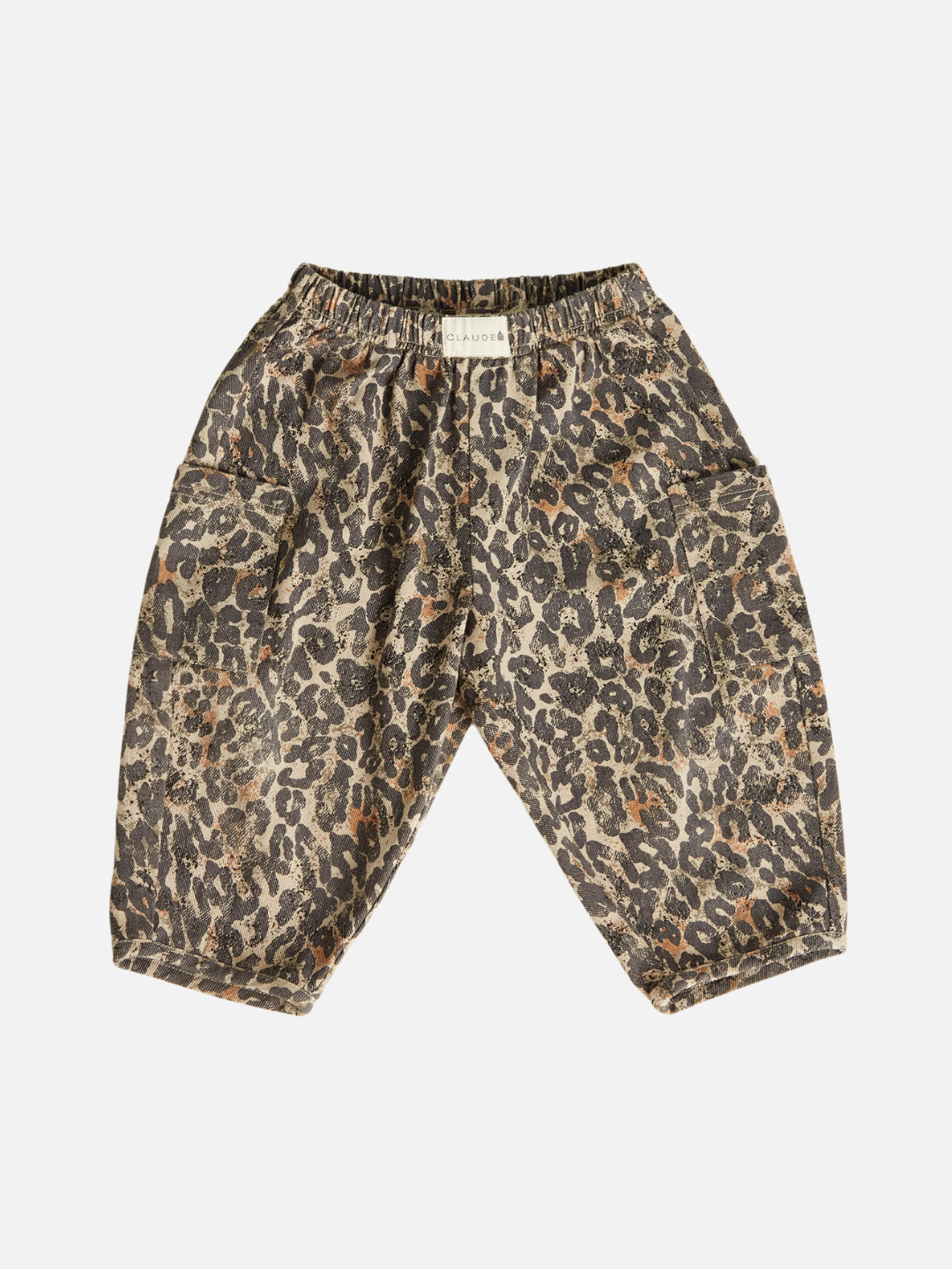 The EMERSON LEOPARD TROUSER is a unisex piece for toddlers, made with soft organic cotton. It has a leopard print design on a crisp white background, featuring an elastic waistband and large pockets.