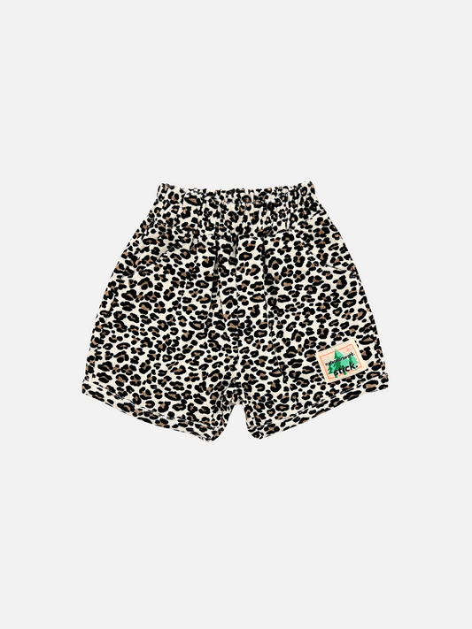 Image of Front view of the kids' Leopard print terrycloth shorts. Stick brand logo on the right leg.