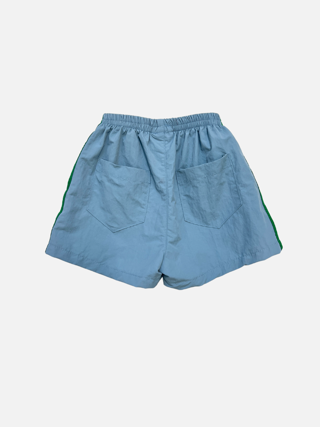 SPRINTER SHORTS in light blue feature an elasticated waist, green side stripes, and two back pockets, shown on a plain white background.