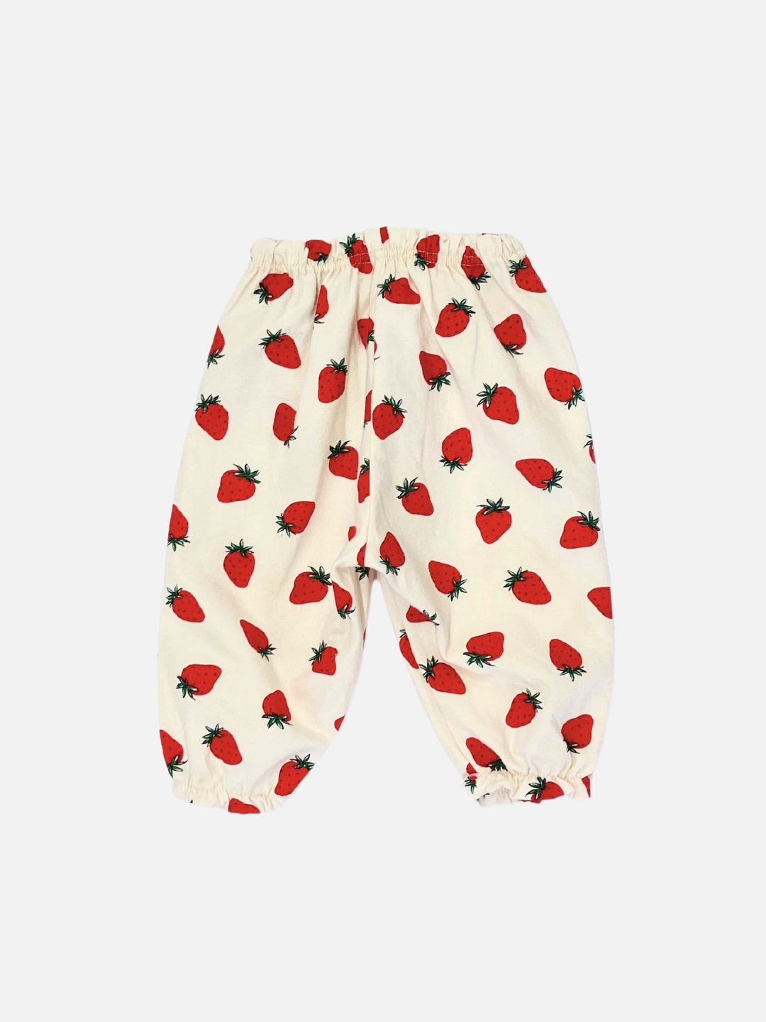 The STRAWBERRY PANTS, featuring a delightful white strawberry print, an elastic waistband, and cuffs, are crafted from soft brushed cotton—perfect for Aosta kids clothing enthusiasts.