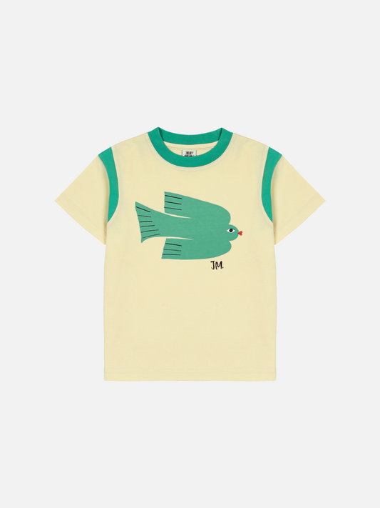 Image of Green Bird T-shirt with yellow body and green sleeves, featuring a stylized fish graphic and "JM" initials on the front.