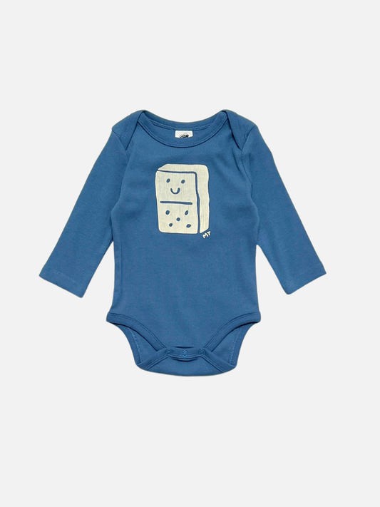 Image of The DOMINO LONG SLEEVE ONESIE in blue is a soft ribbed cotton bodysuit with long sleeves, featuring a playful white smiley domino graphic on the front, shown against a white background.