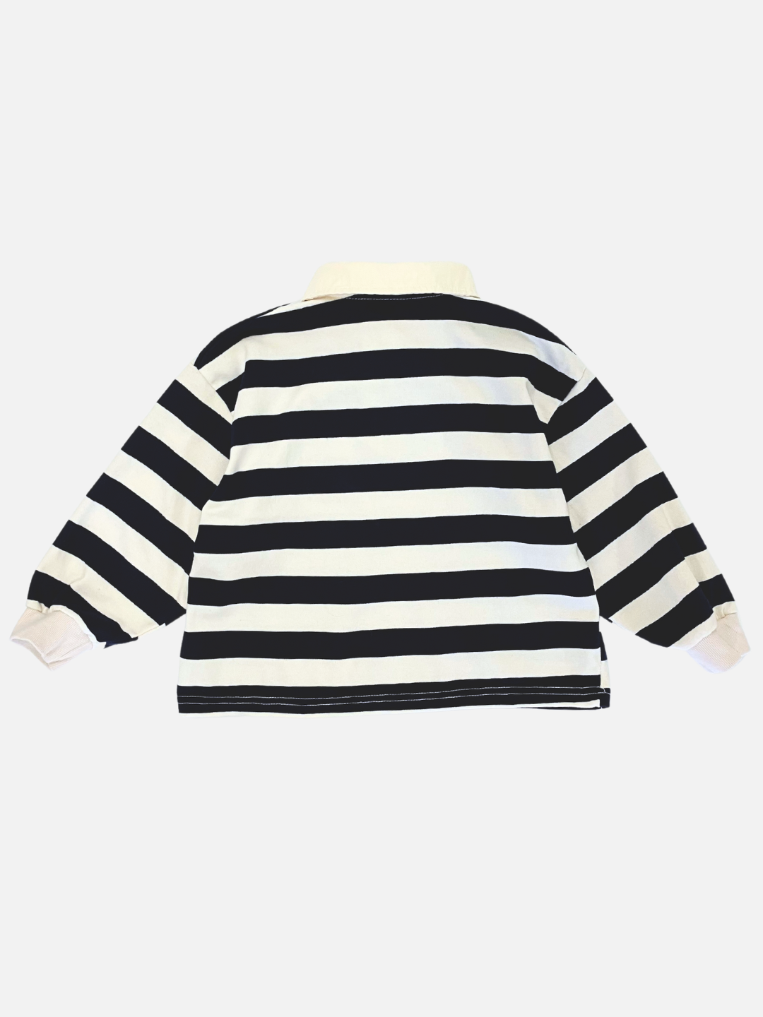 Cream | The RUGBY LONGSLEEVE features black and white horizontal stripes, a light-colored collar, and is crafted from soft cotton jersey. It is displayed flat against a white background.