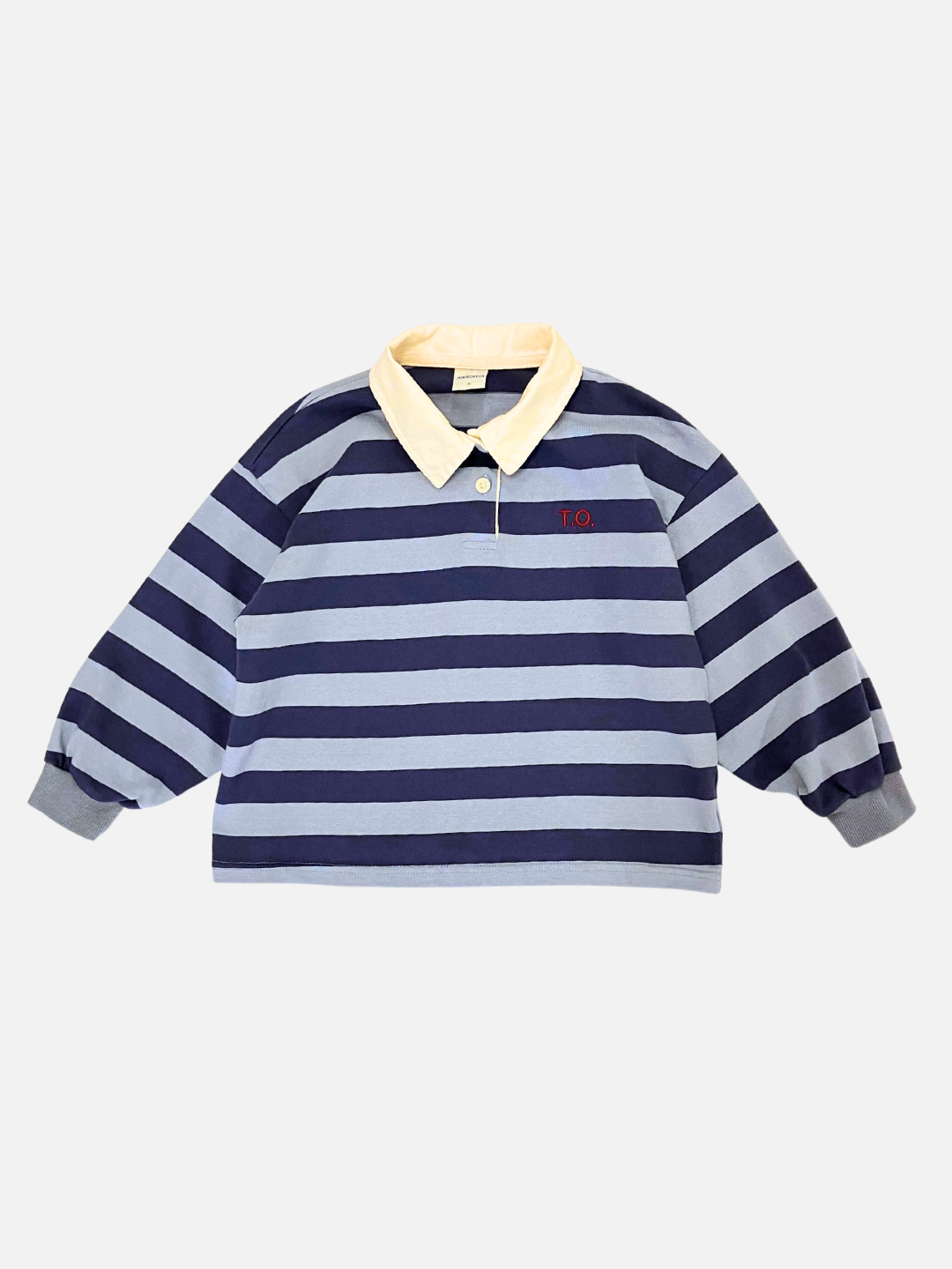 Blue | Introducing the RUGBY LONGSLEEVE, a stylish long-sleeve shirt in blue and gray stripes from a popular Korean kids’ brand. It features a yellow collar with a button placket and "T.O." embroidered on the chest. Made from soft cotton jersey, this piece ensures ultimate comfort.