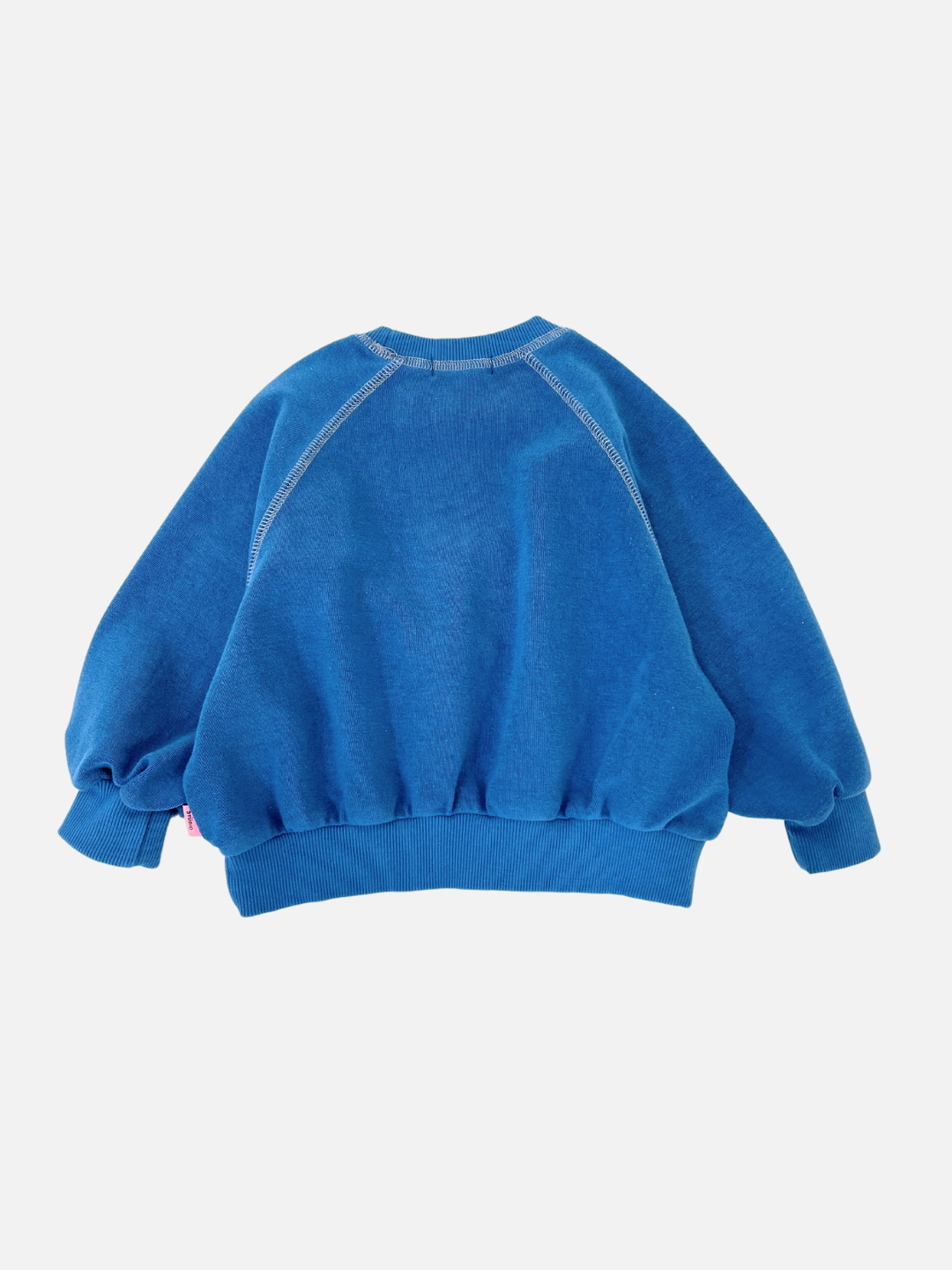 Blue | The VARSITY SWEATSHIRT by Cantucci Studios features a retro style with blue brushed cotton, an oversized fit, long sleeves, and visible seams against a white background.