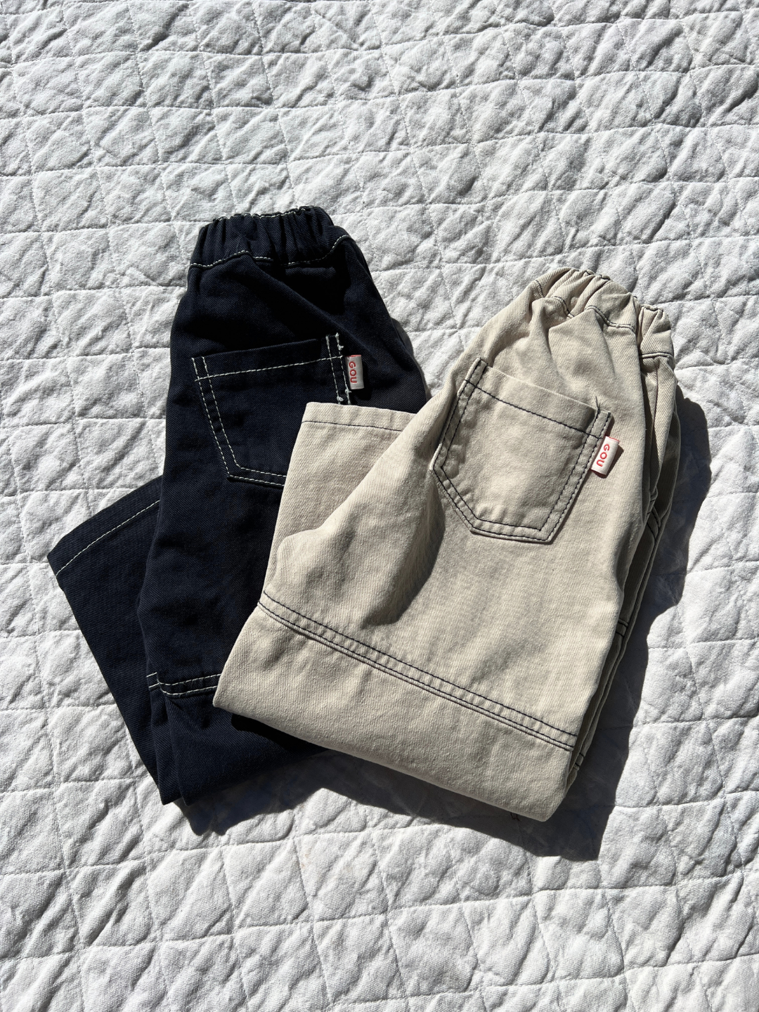 Stone | Stone & Dark Indigo Stitch Jean laid on blanket