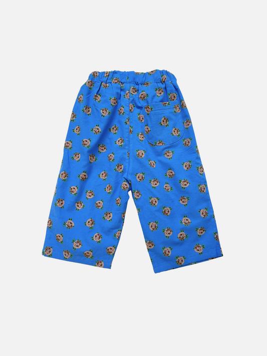 Second image of ROSETTE PANTS: Blue wide-leg cotton poplin trousers featuring an elastic waistband and all-over floral screen-print, from a stylish Korean kids label. Displayed on a plain white background.