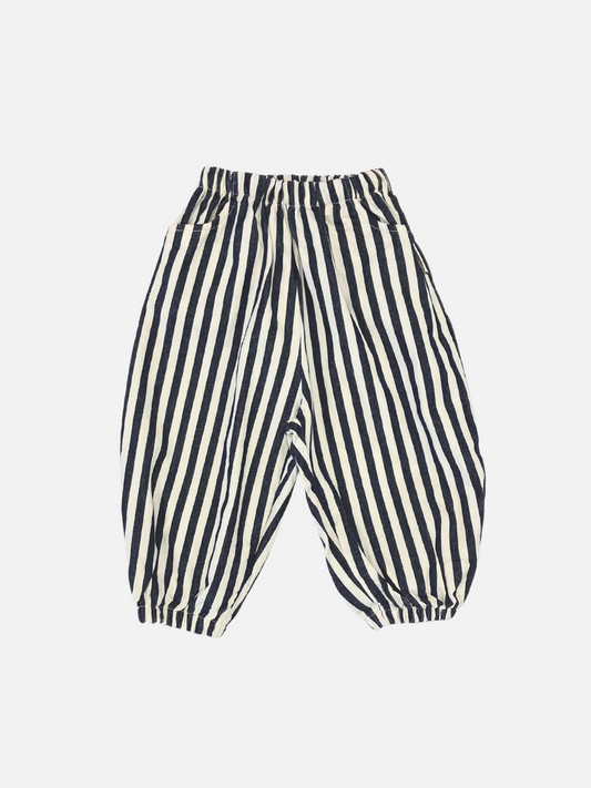 Image of Navy Stripe | Navy vertically striped cotton "PIRATE PANTS" with a balloon leg design, featuring an elastic waistband and hemmed cuffs, displayed against a plain white background.