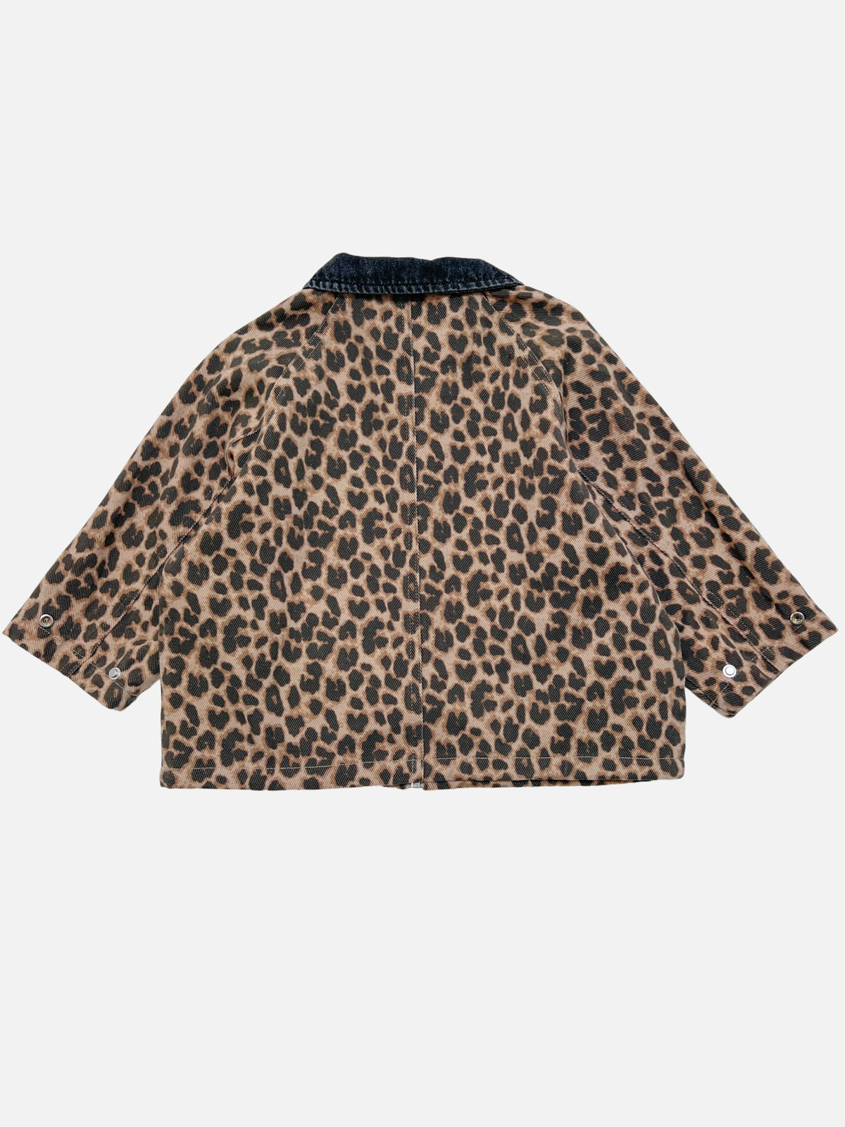 A kids chore jacket with a brown and black leopard print pattern and a dark denim collar, shown from the back on a light gray background.