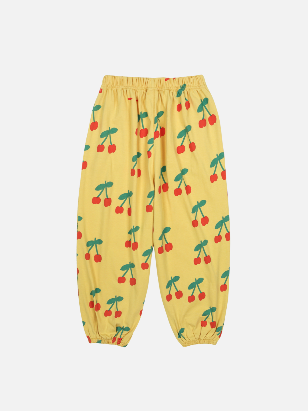 The CHERRY PUFFY PANTS are yellow with an elastic waistband and cuffs, and they display a pattern of red cherries with green stems.