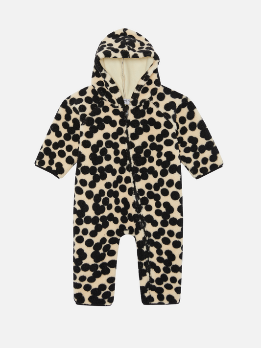 Image of The SPOT STROLLER SUIT, an infant's hooded jumpsuit with a white base and black polka dot pattern, features a convenient zipper closure down the front. Perfect for babies and new arrivals, this adorable piece ensures both comfort and style.