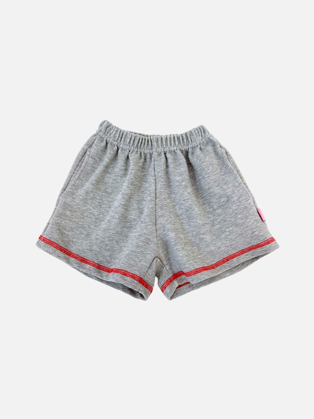 Grey | The VARSITY SWEAT SHORTS in grey feature a vintage-inspired fit with red stitching along the bottom hem, an elastic waistband, and are crafted from brushed cotton for a soft feel. Displayed on a plain white background.