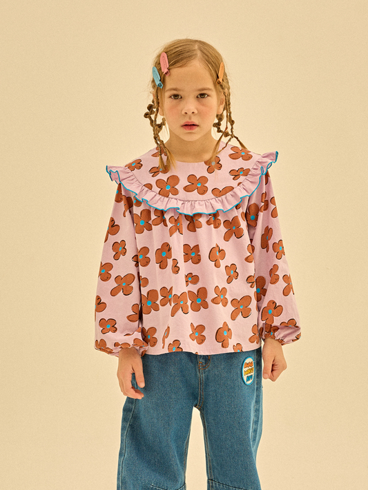 Second image of FLOWER FRILL BLOUSE - A long-sleeve children's dress with a purple background and brown floral pattern, featuring a ruffled collar with blue trim. Built for durability according to care instructions.