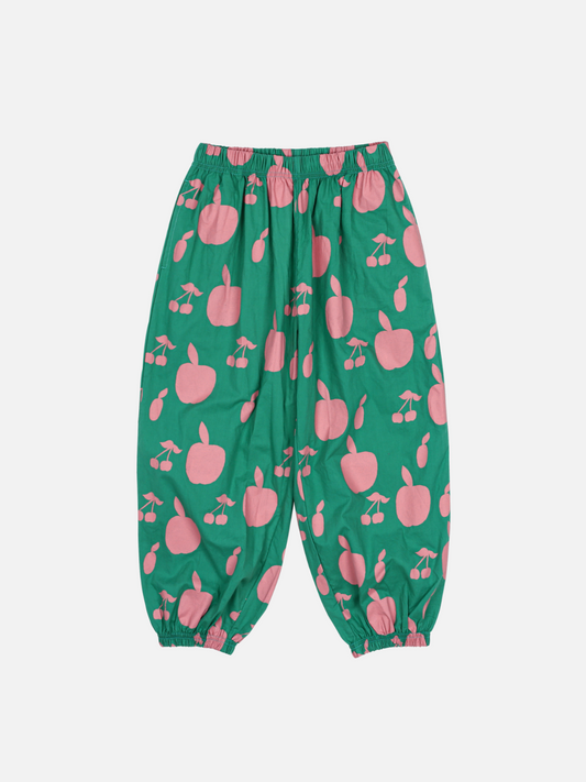 Image of FRUIT LOUNGE PANTS are green with an elastic waistband and cuffs, featuring pink apple and cherry patterns.