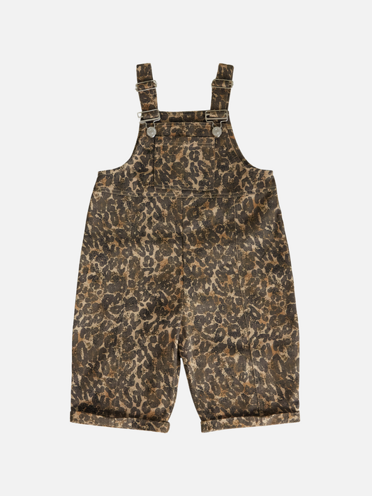 Image of The BLYTHE LEOPARD DUNGAREE features brown leopard print, adjustable shoulder straps, and front metal buckles, displayed flat on a white background. Shipping costs may apply.