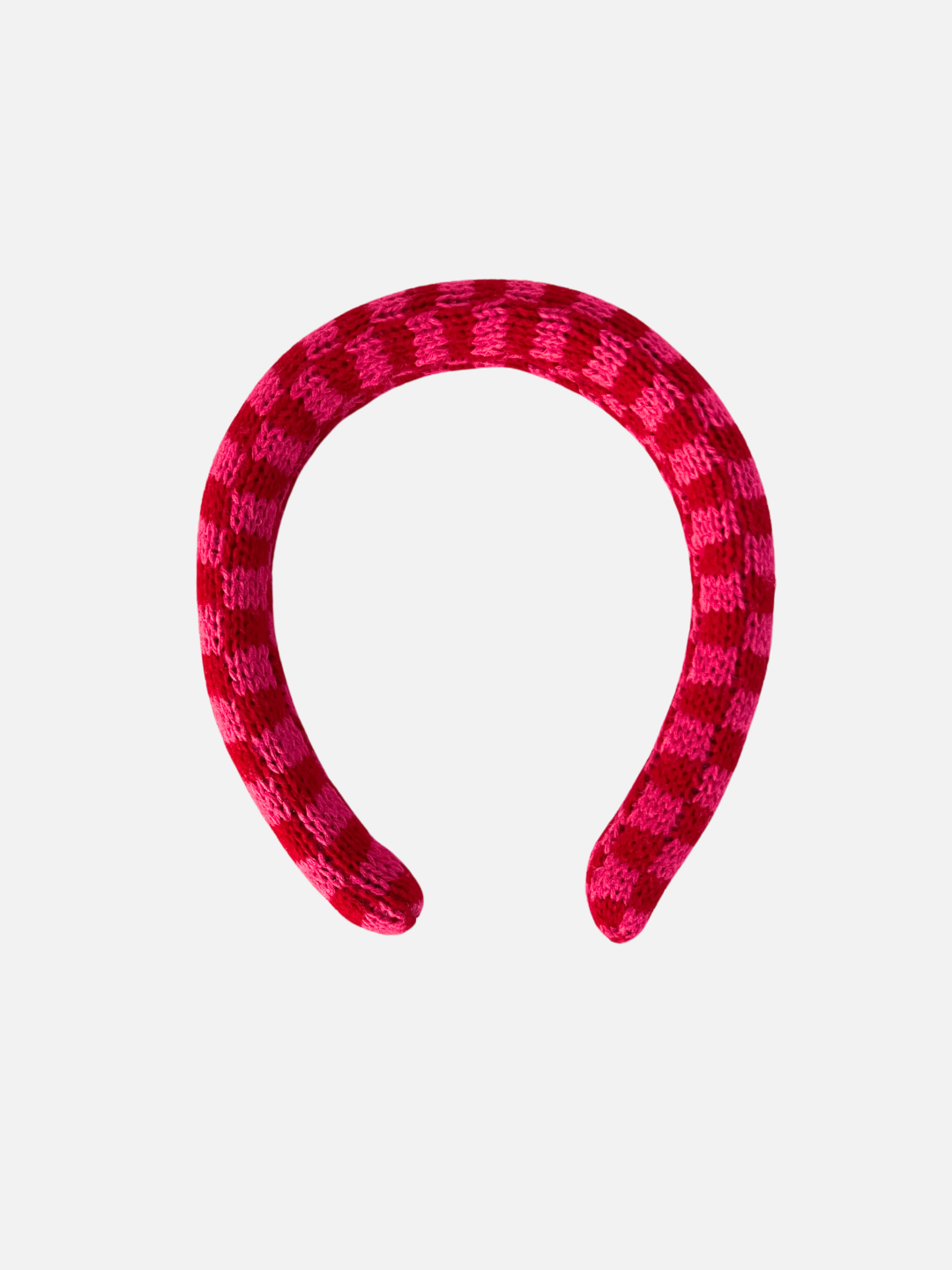 A kids' knitted headband in a pink and red check