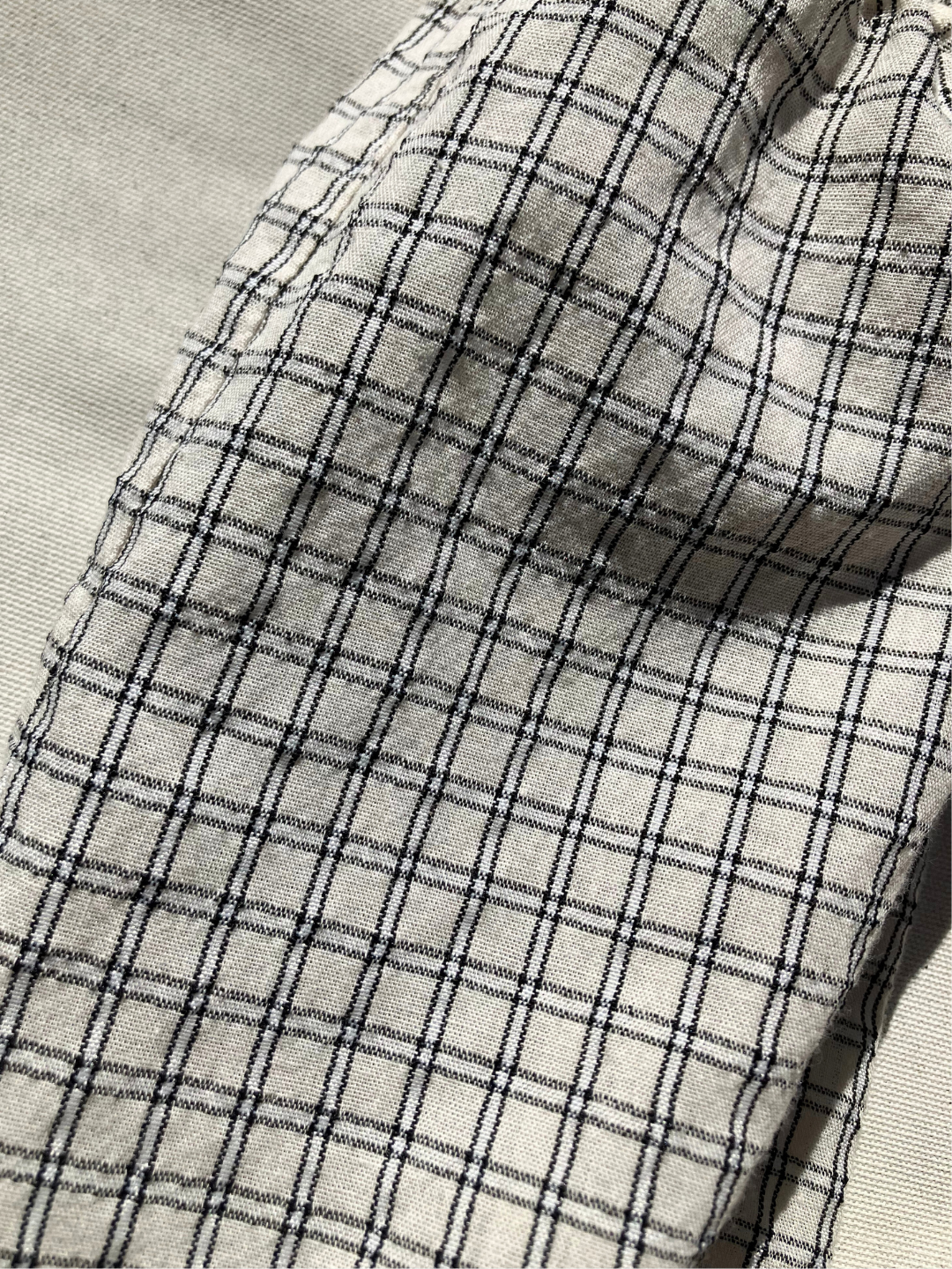 Close up of the grid check pull-on pant all over grid pattern. 