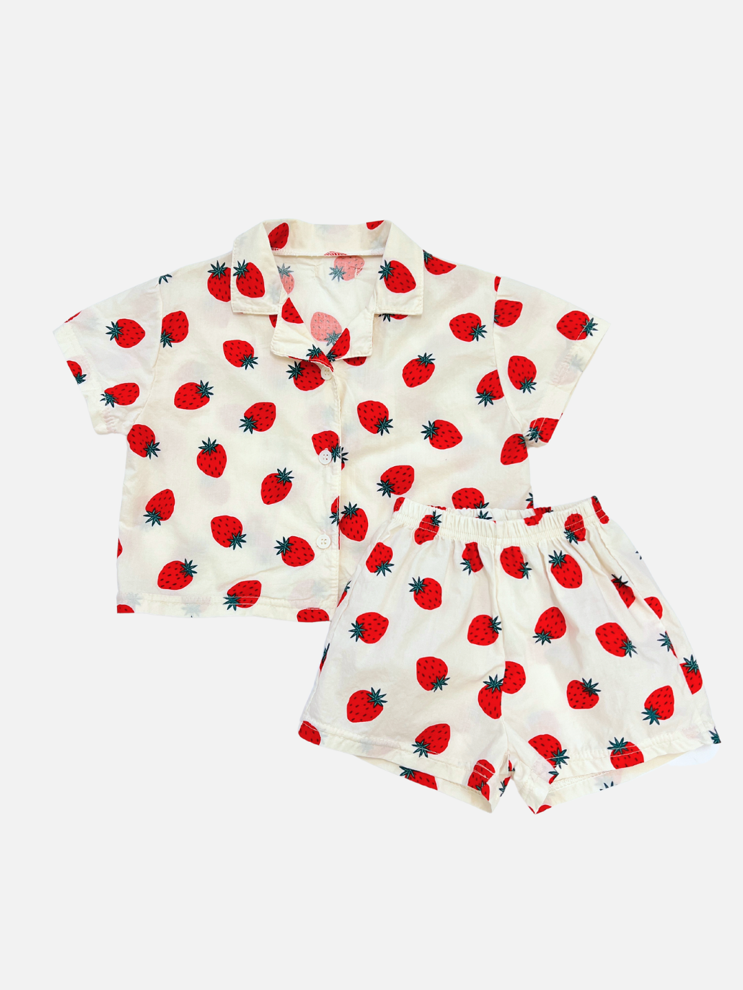 A front view of the baby Berry Season Set. Classic all over strawberry print, this set includes a button up top and shorts in ivory. The top features an oversized and boxy fit.