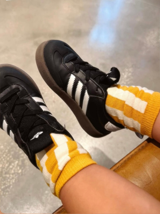 Second image of Marigold | A pair of comfy STRIPE SOCK in marigold with vertical white stripes, crafted from stretchy cotton, on a plain white background.