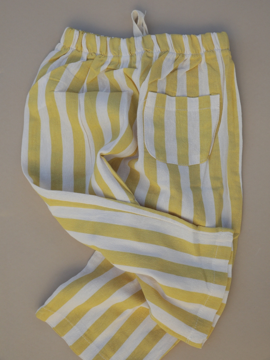 Yellow | A back view of the yellow stripe pants