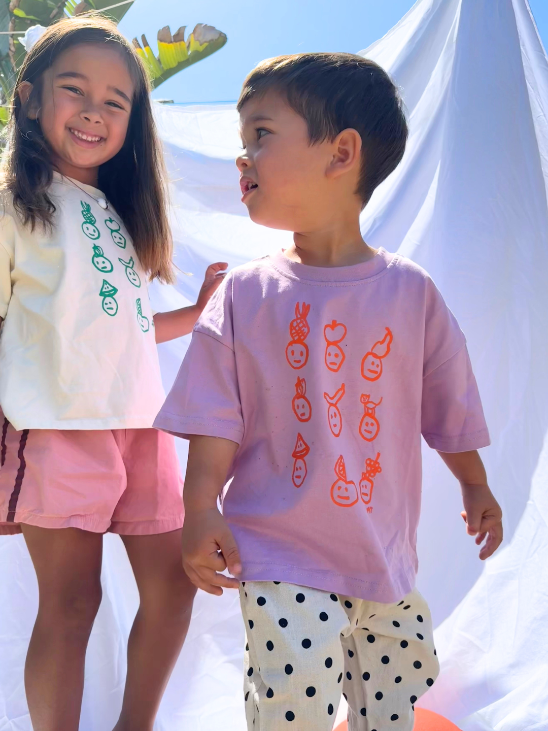 Two kids in both colorways of the Fruit Face tee.