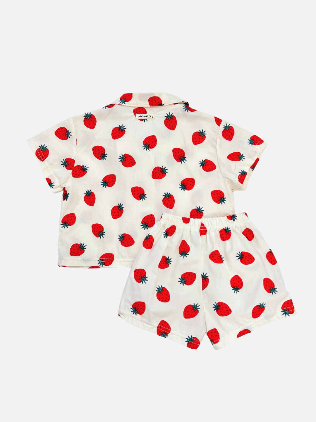 A back view of the baby Berry Season Set. Classic all over strawberry print, this set includes a button up top and shorts in ivory. The top features an oversized and boxy fit.