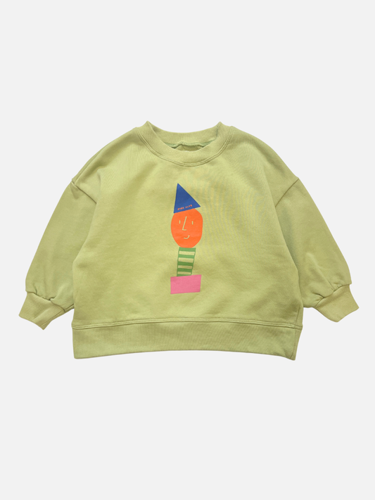 Image of Light green STACKED POTATO SWEATSHIRT featuring an oversized fit and a colorful abstract face design with geometric shapes in orange, blue, green, and pink on the front.