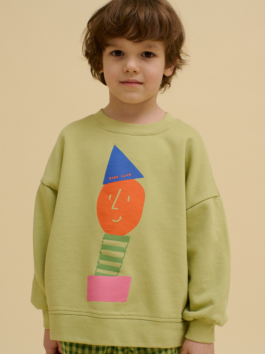 Second image of Light green STACKED POTATO SWEATSHIRT featuring an oversized fit and a colorful abstract face design with geometric shapes in orange, blue, green, and pink on the front.