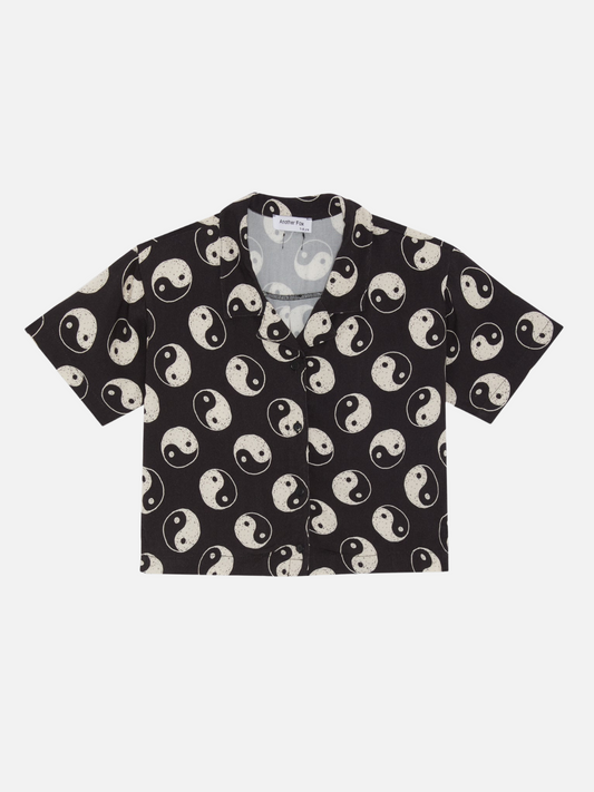 Image of A front view of the black button up shirt with a yin and yang pattern all over.