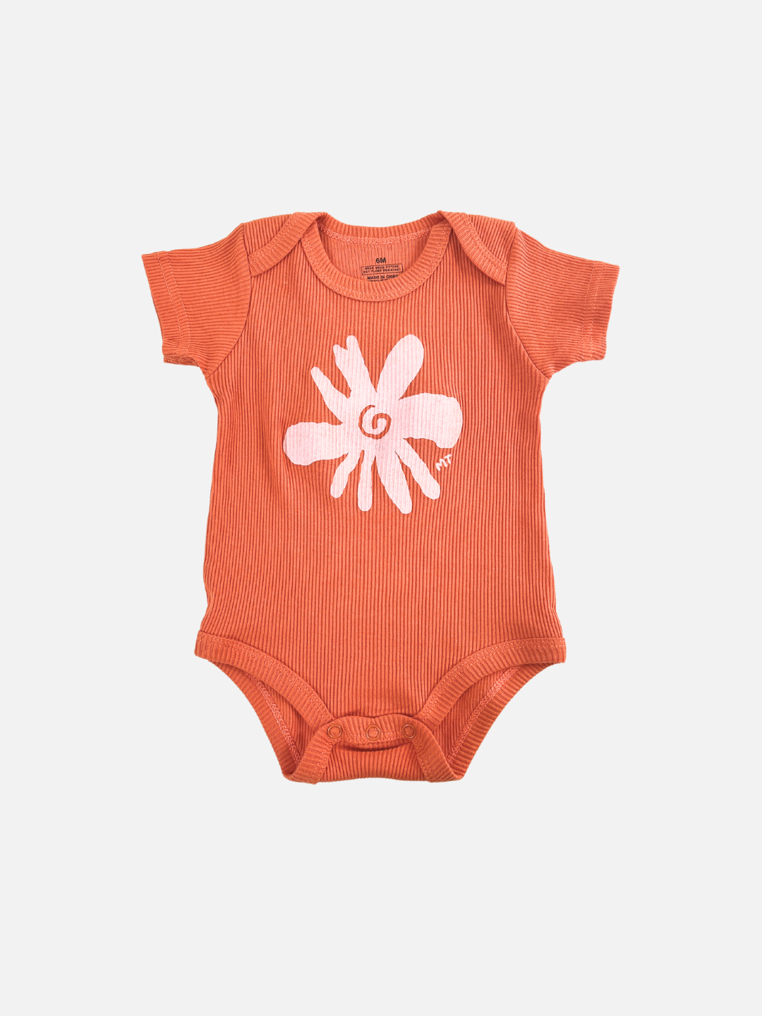 Orange | The RIBBED COTTON ONESIE in orange features short sleeves and a delightful white flower design on the front. Perfect for comfort and style, it's part of Milk Teeth's Baby Bodysuits collection, shown on a plain white background.