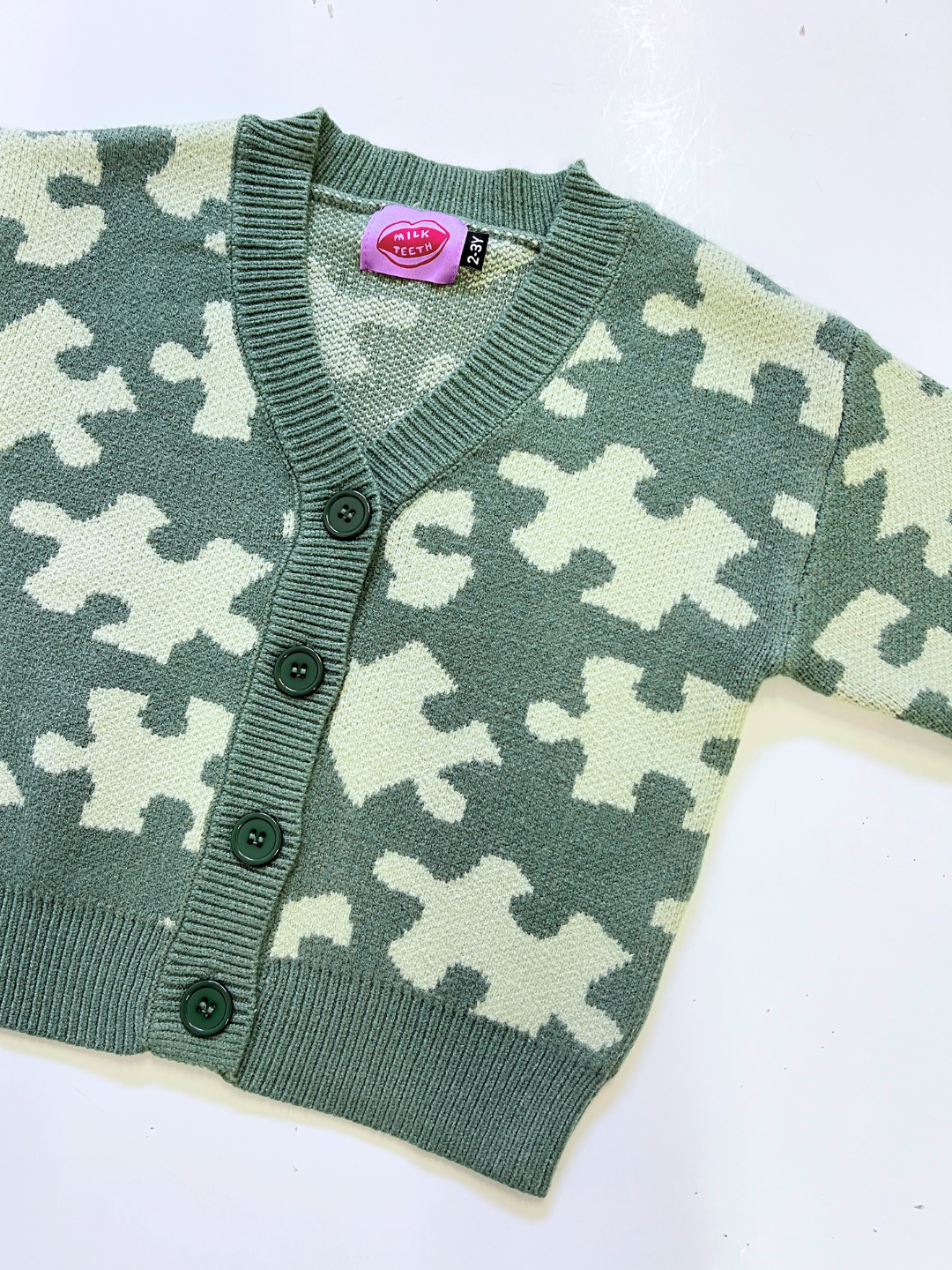 Green | Green and white patterned cardigan on a white background