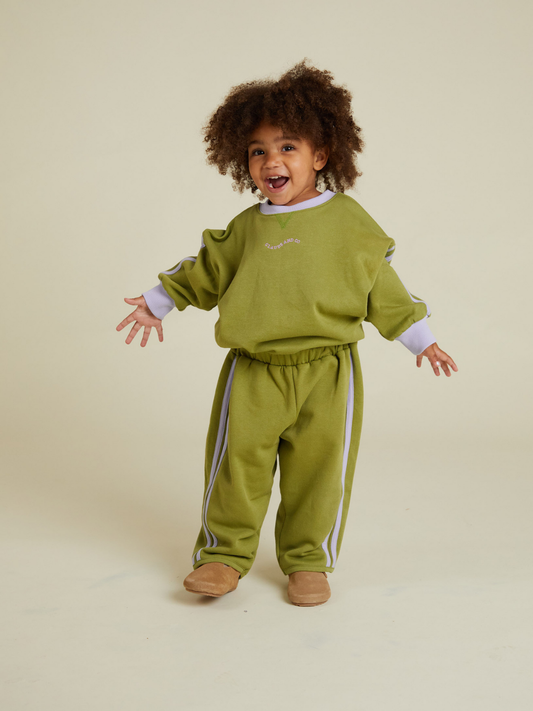 Second image of ALVIE MATCHA SWEATPANT: Olive green wide-leg children's pants with an elastic waistband and white side stripes, shown against a plain white background.