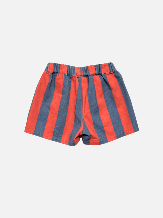 Second image of Front view of red and blue striped kids shorts on a light gray background