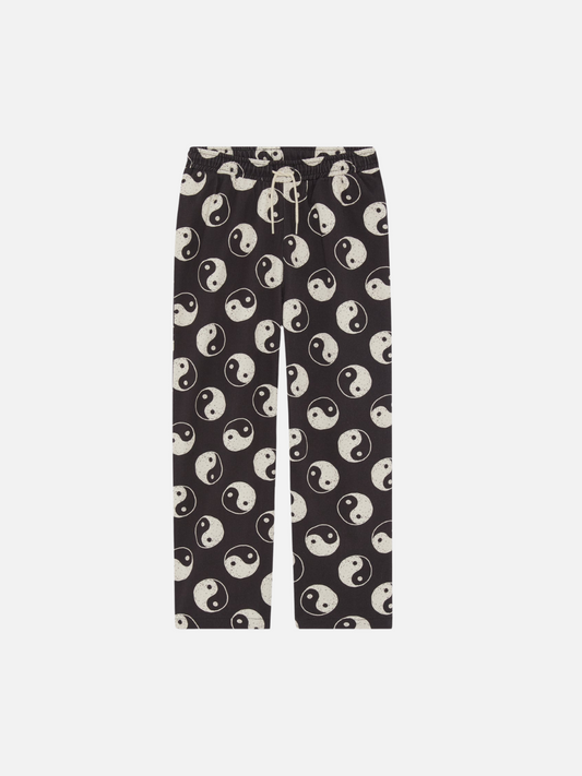 Image of A front view of the drawstring black pants with a yin and yang pattern all over.