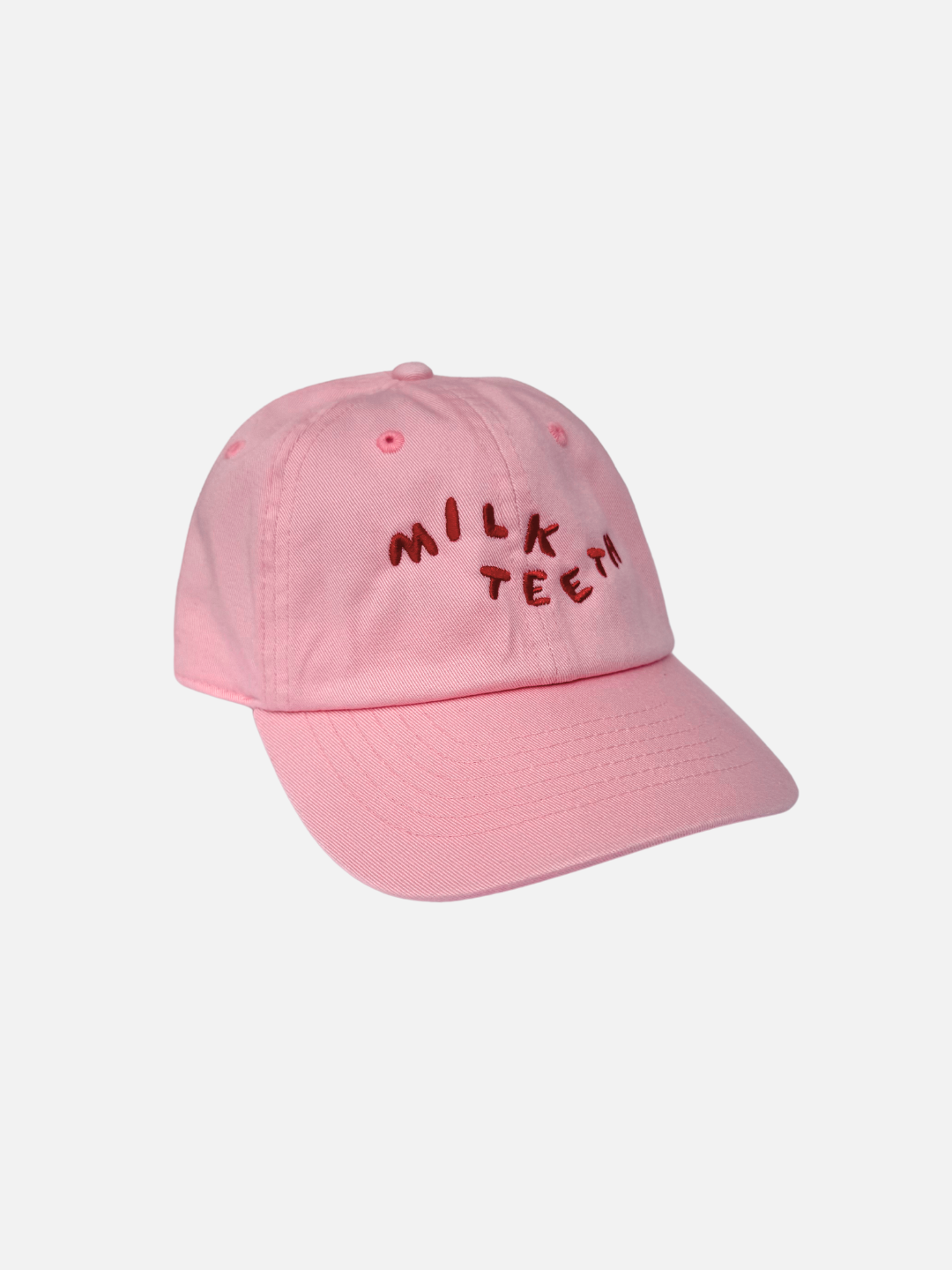 A front view of the Milk Teeth Cap with red orange embroidery