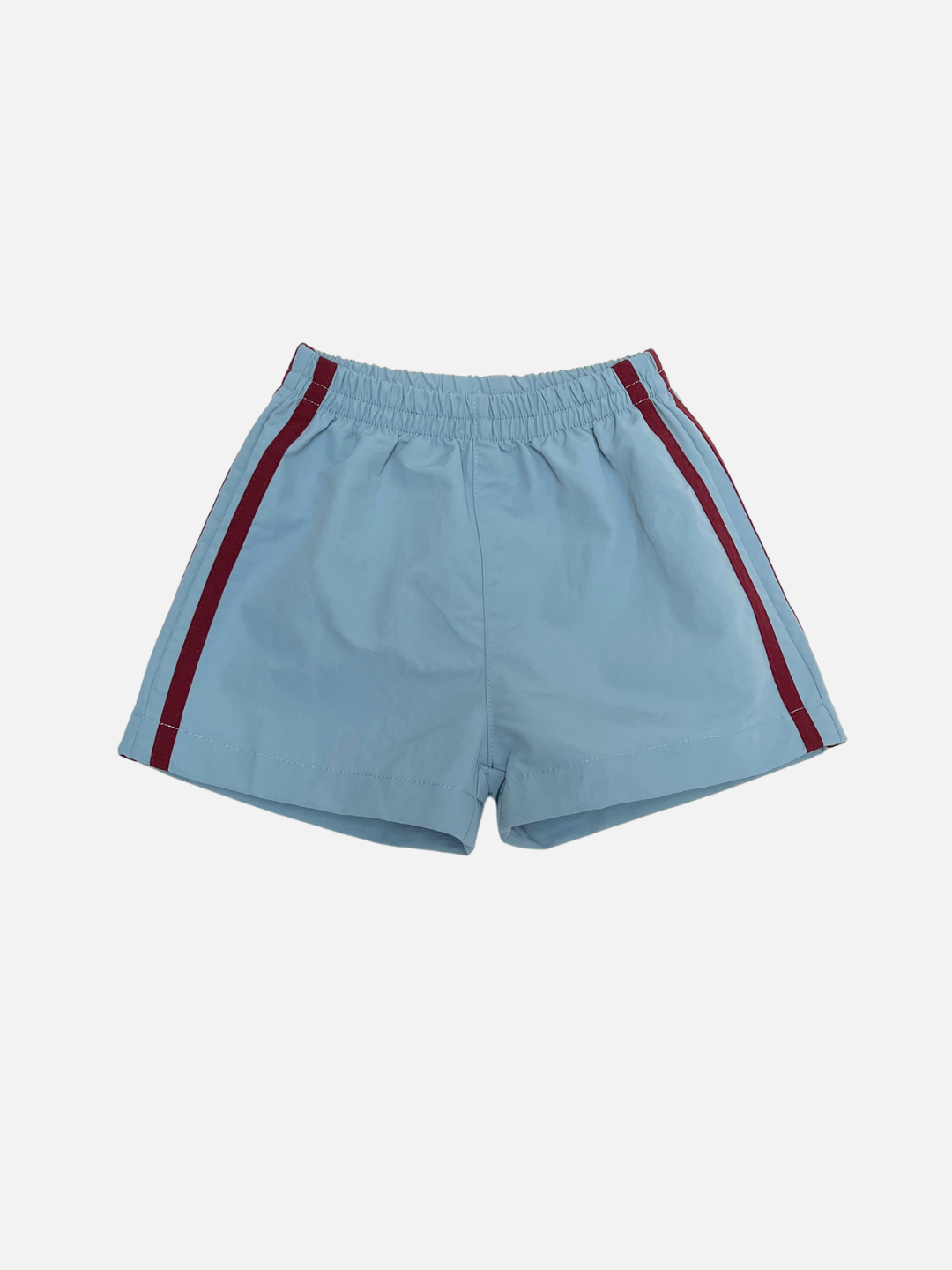 SPRINTER SHORTS in light blue featuring an elastic waistband and red vertical side stripes, shown on a plain white background.