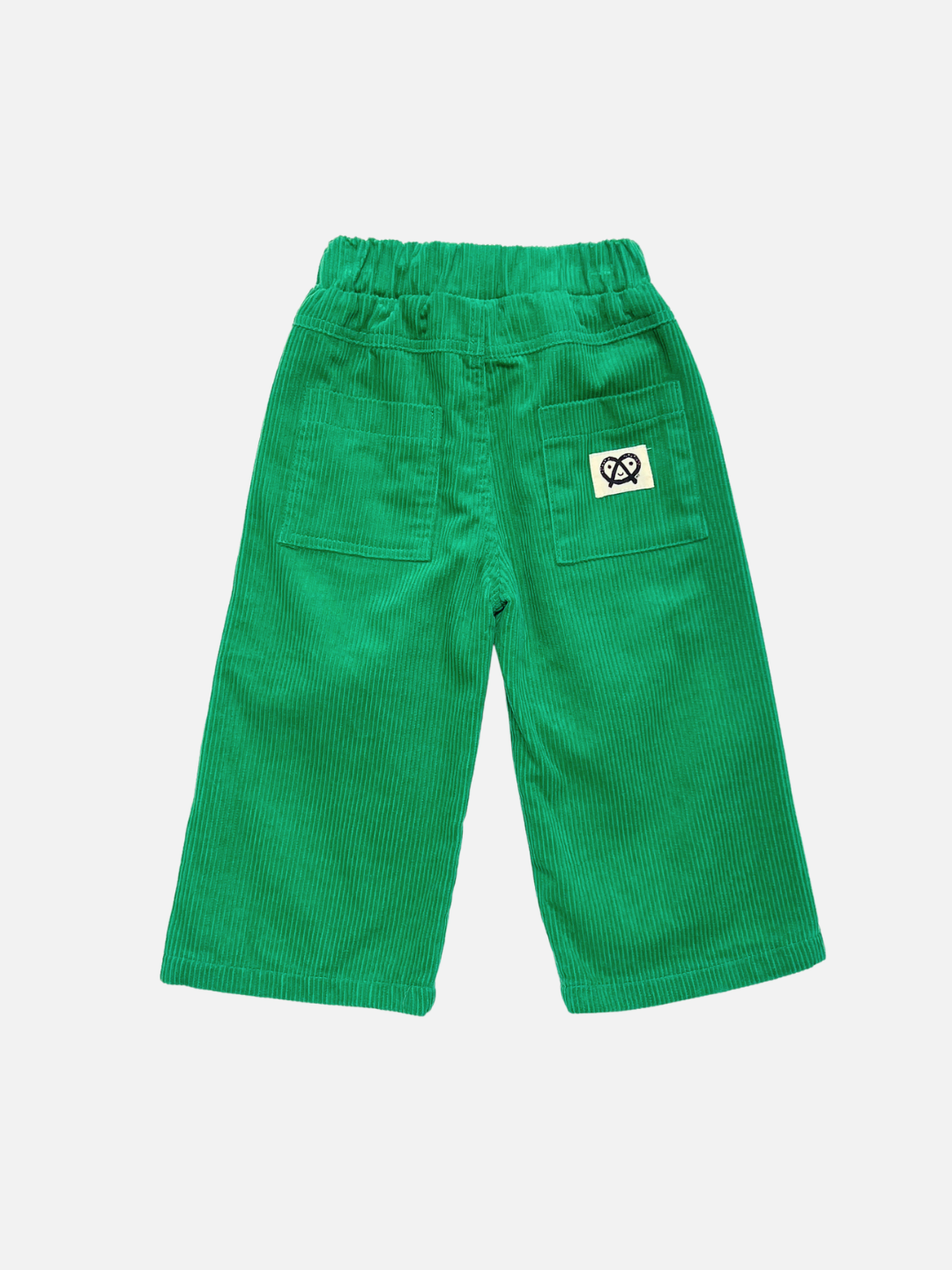 Green |  Back view of green corduroy pants for toddlers, featuring an elastic waistband, two back patch pockets, and a small white square patch with a black logo on the right back pocket, shown against a light gray background.