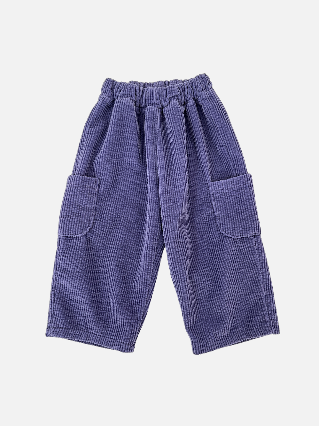 Purple | The CORD POCKET PANT is a pair of baggy bluish-purple corduroy pants from a trendy Korean kids brand, showcasing an elastic waistband and two large side pockets, set against a white background