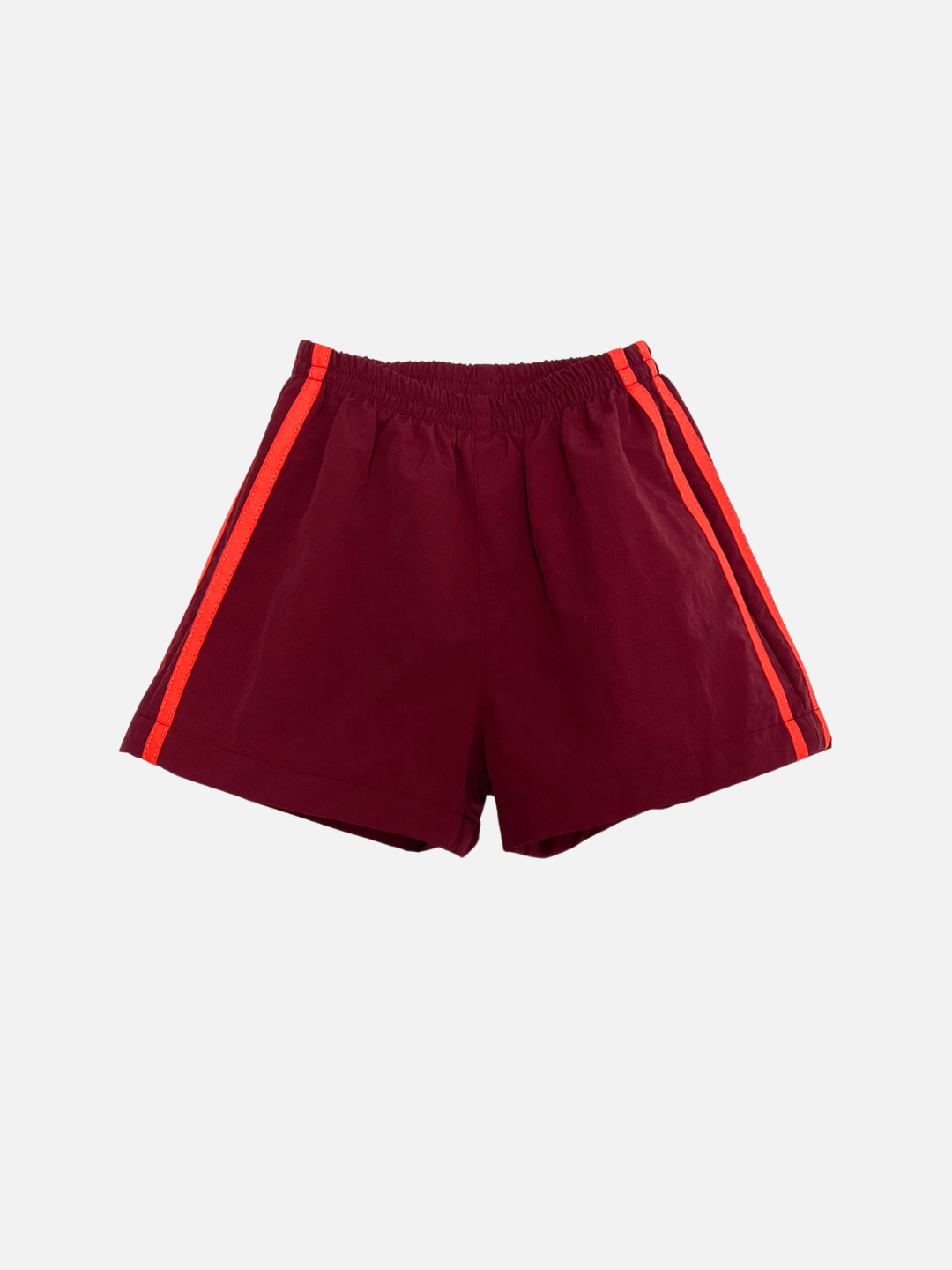 SPRINTER SHORTS in burgundy, featuring an elastic waistband and red-orange side stripes, shown on a plain white background.
