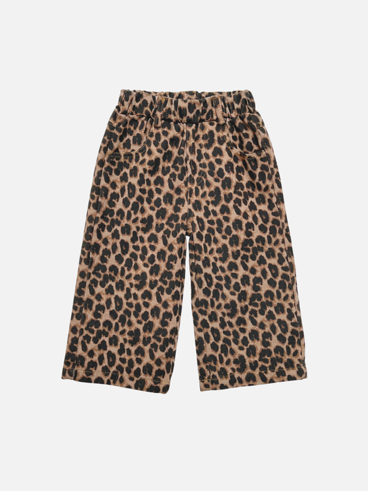 Image of A pair of wide-leg kids jeans in a classic leopard print pattern in beige, brown, and black, displayed against a solid light gray background.