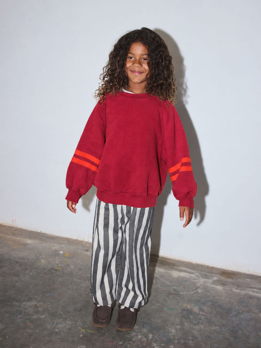 Second image of Red | Front view of kids crewneck sweatshirt in red with two bright red-orange stripes on each sleeve