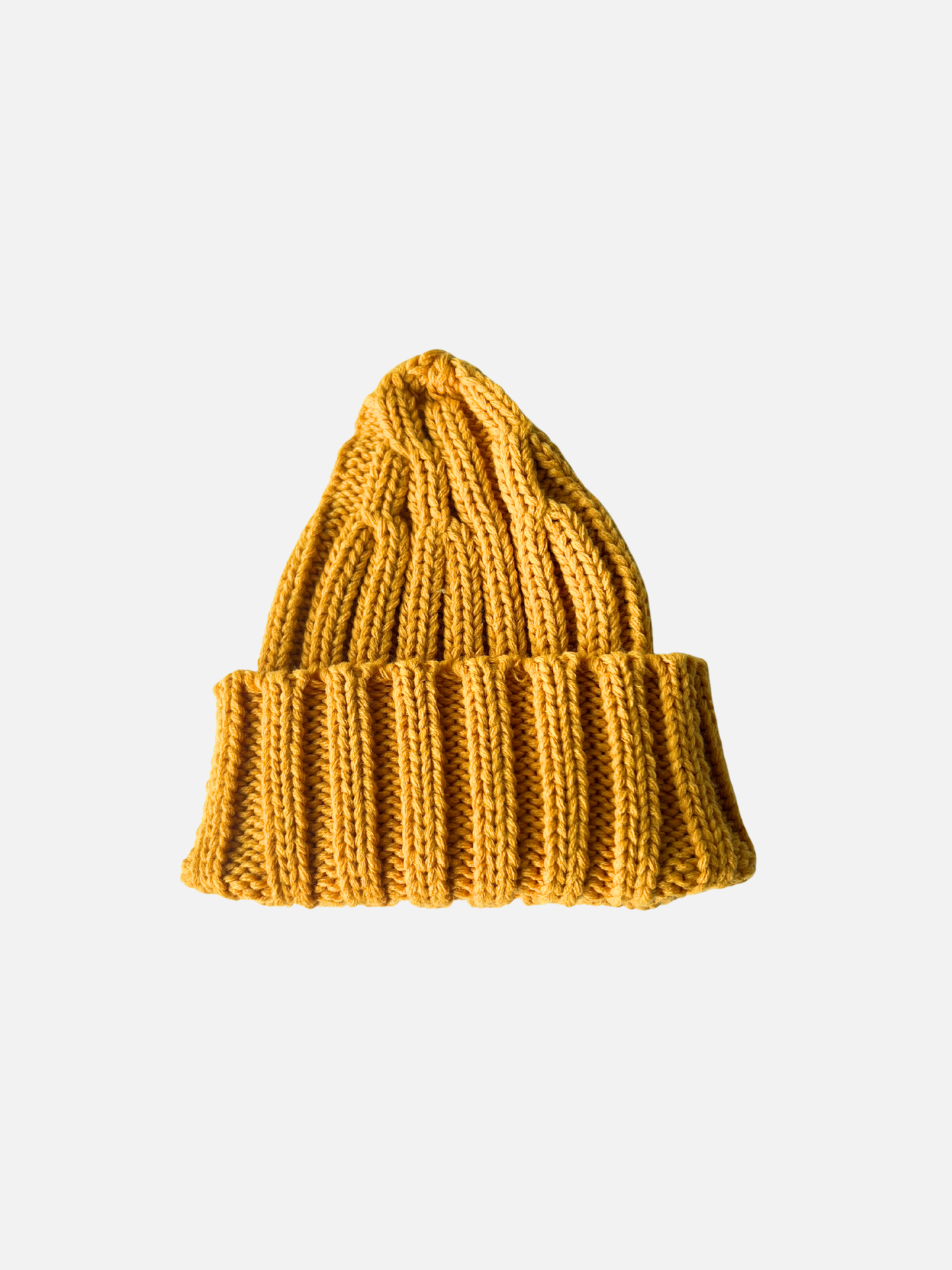 Mustard | The CHUNKY RIB KNIT BEANIE in mustard features a chunky ribbed knit, adjustable cuff, and folded brim, shown against a plain white background.
