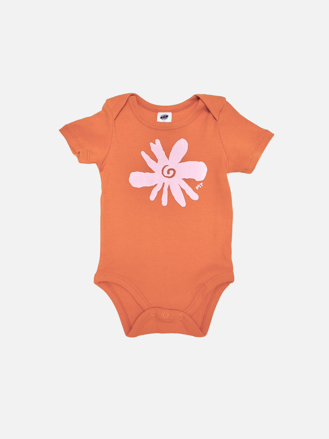 The FLOWER SHORT SLEEVE ONESIE in orange features short sleeves and a large light pink abstract flower on the front—designed for easy diaper changes.