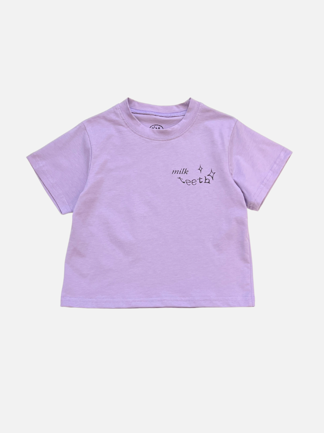 Purple | The MILK TEETH TEE is a purple short-sleeve shirt featuring "milk teeth" and small star designs on the left chest—perfect for fans of unique artist-designed tees.
