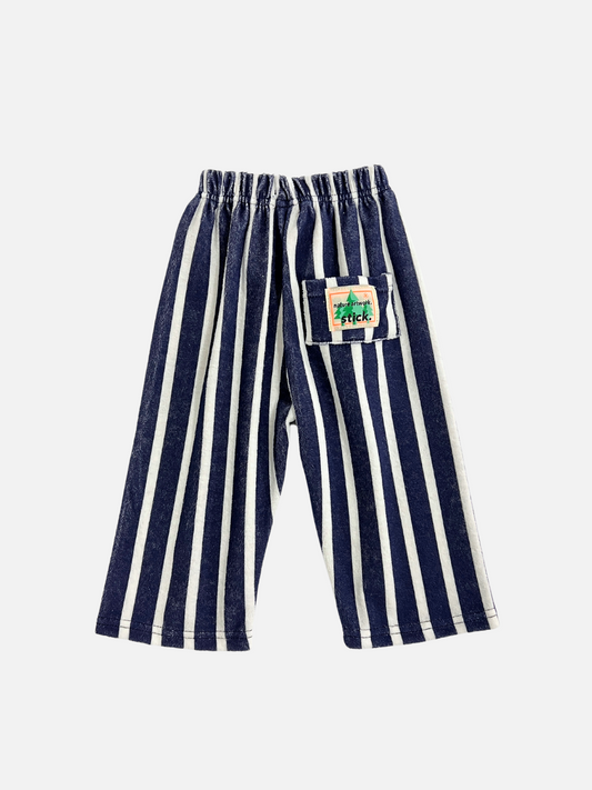Second image of Front view of the Paint Roller Pants in Terry fabric white/navy stripes. "Stick" patch logo on the left leg in cream and orange. 