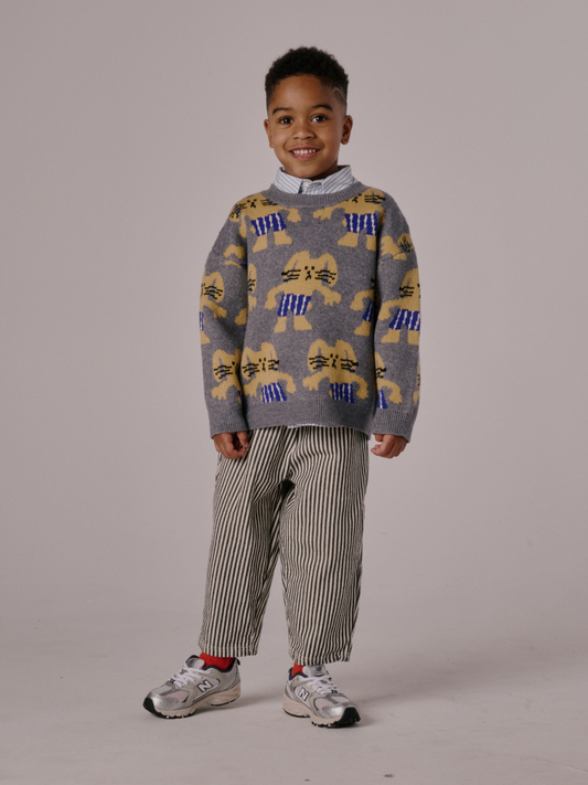 Second image of Gray | The MAX SWEATER is a gray knit featuring a repeating pattern of yellow cartoon bunnies in blue striped pants.