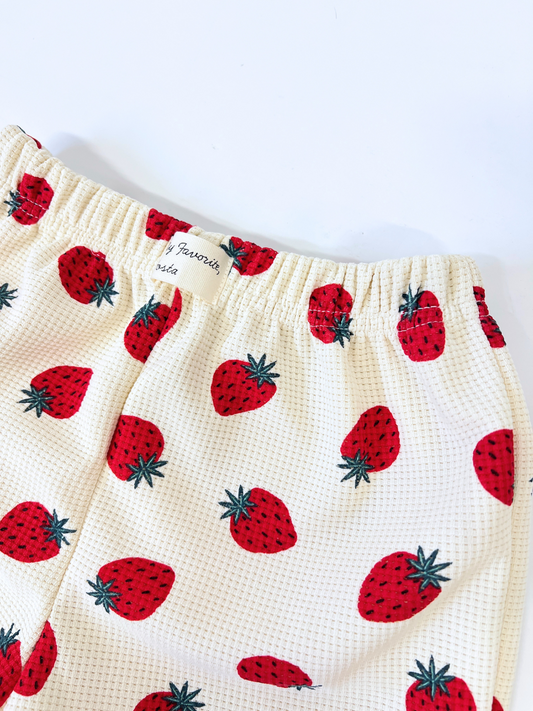 Second image of The STRAWBERRY WAFFLE SHORTS showcase red strawberries with green leaves on a plain white background.